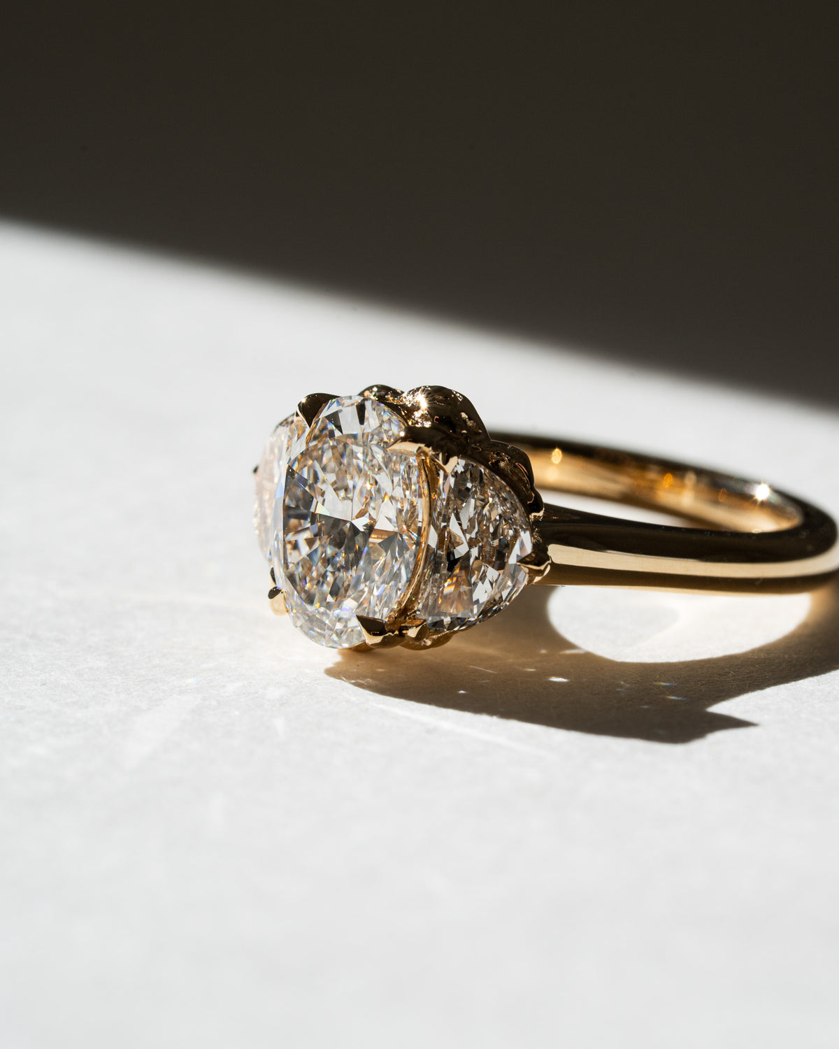 Oval diamond with half moon trilogy