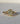 Natural oval diamond three-stone engagement ring in 18k yellow gold with custom kite side stones, front view close-up