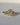 Natural oval diamond three-stone engagement ring in 18k yellow gold with custom kite side stones, front view close-up