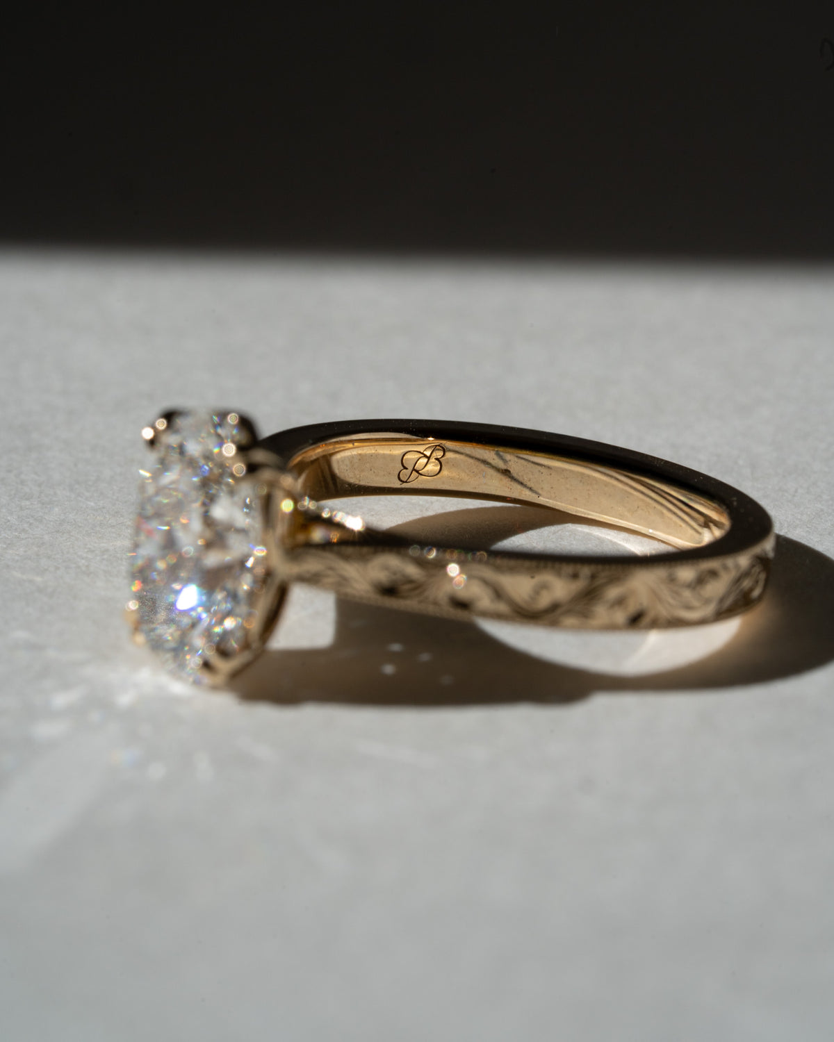 Old mine oval with hand-engraved scroll band
