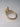 Side view of marquise diamond engagement ring showing cathedral setting and pavé diamond band in yellow gold