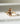 Gold ring with a large brown diamond on a light background