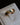 Brushed 18k gold wedding band with custom parallelogram emerald centre stone