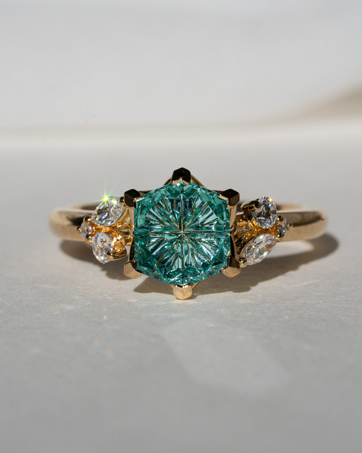 Aqua hexagon sapphire with leafy side stones