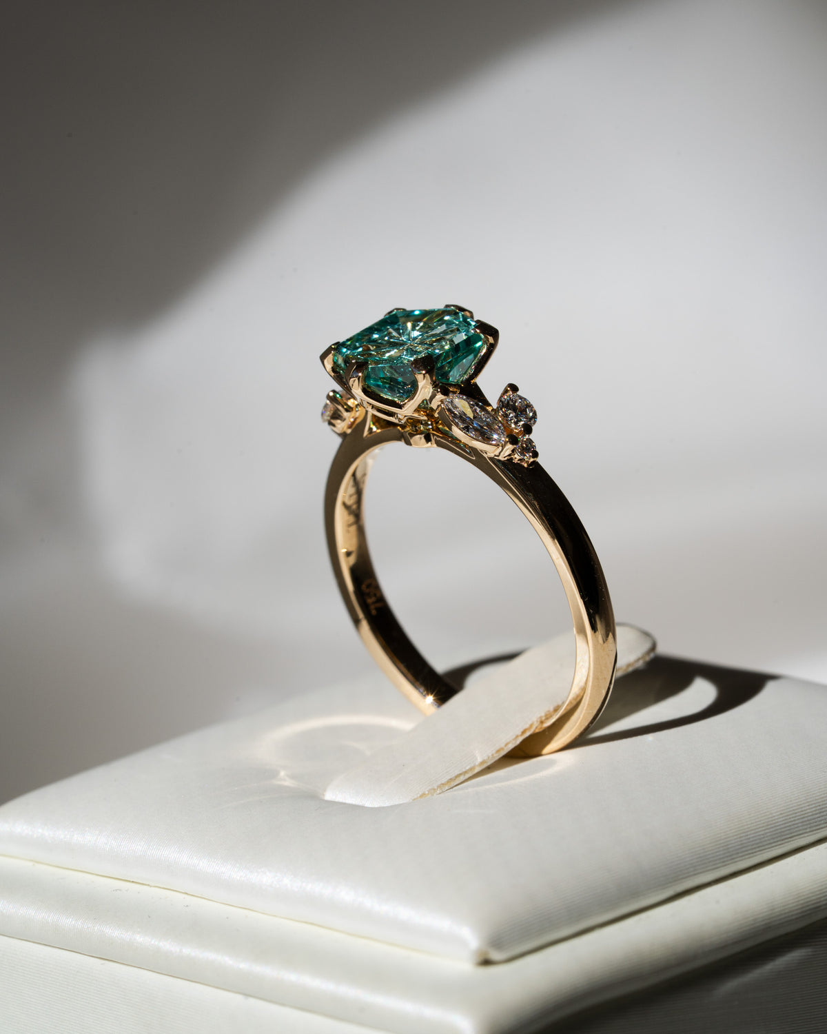 Aqua hexagon sapphire with leafy side stones