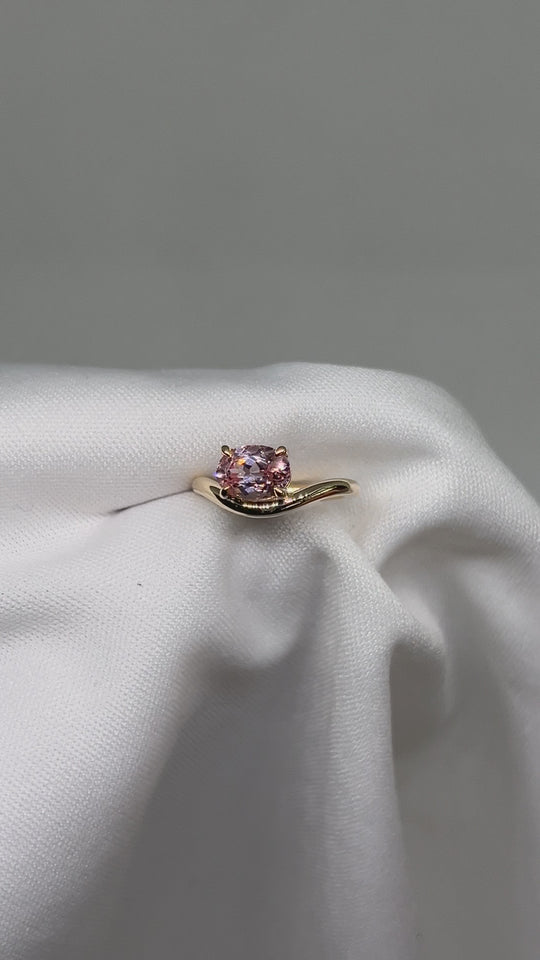 14k & 18k Gold ring with a pink gemstone on a curved band set in prongs