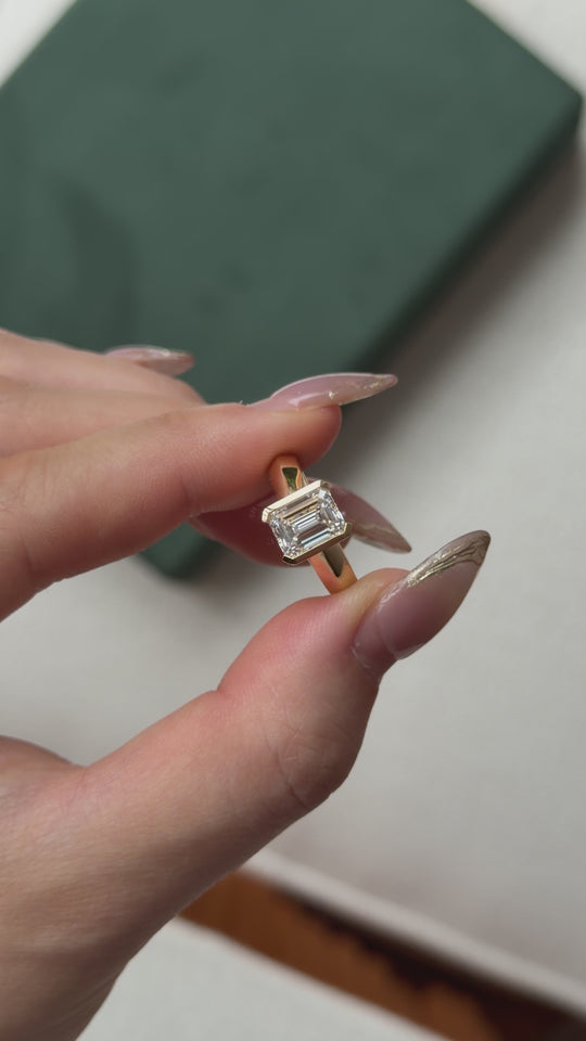 Knife edge yellow gold band with emerald cut diamond, unique engagement ring design Australia